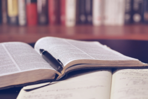 Open Bible and notebook representing obedience to God through reading and following His Word